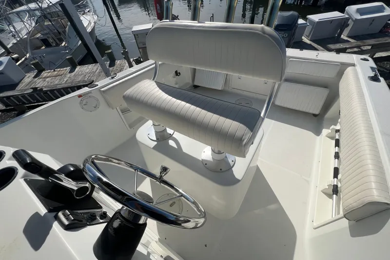 Slide: The Image of 2000 Hydra-Sports 230 Seahorse CC boat interior with steering wheel and seating. - 11
