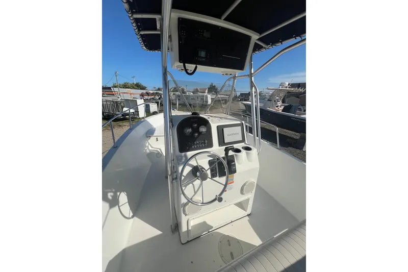 Slide: The Image of 2000 Hydra-Sports 230 Seahorse CC boat cockpit with steering wheel and Garmin navigation system. - 12
