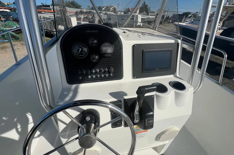 Slide: The Image of Console of 2000 Hydra-Sports 230 Seahorse CC boat with steering wheel and gauges. - 13