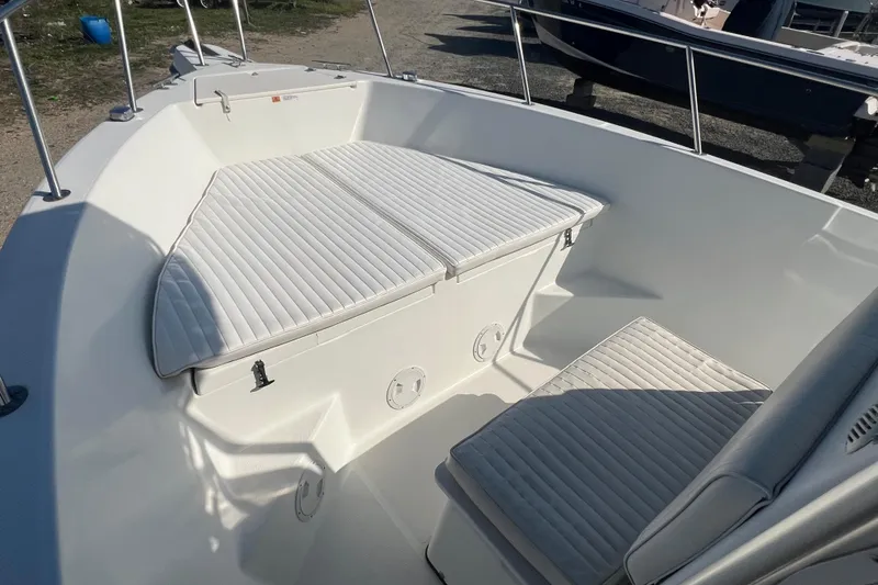 Slide: The Image of 2000 Hydra-Sports 230 Seahorse CC boat interior with cushioned seating and storage. - 15
