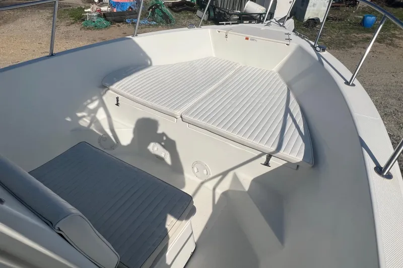 Slide: The Image of 2000 Hydra-Sports 230 Seahorse CC boat interior with cushioned seating and railings. - 16