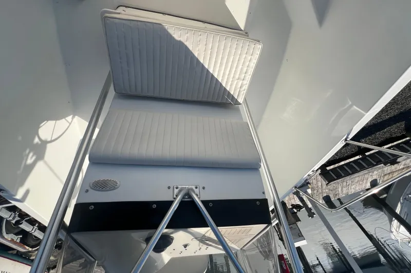 Slide: The Image of 2000 Hydra-Sports 230 Seahorse CC boat interior with cushioned seating and railing. - 19
