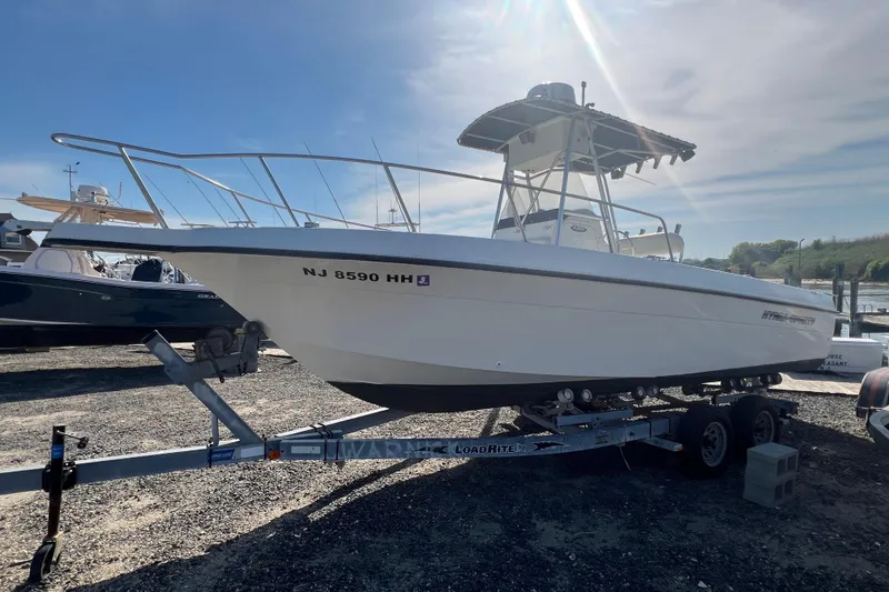Slide: The Image of 2000 Hydra-Sports 230 Seahorse CC boat on trailer under sunny sky. - 2