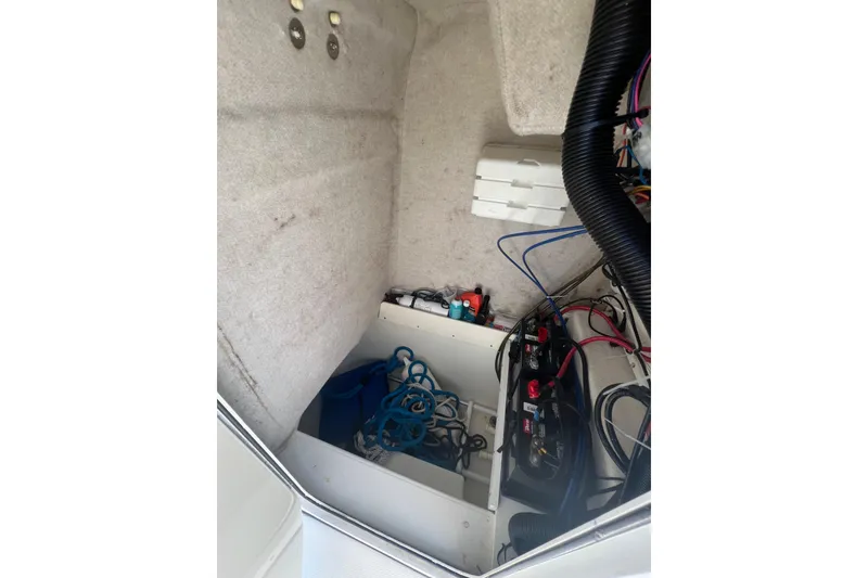 Slide: The Image of Interior view of a 2000 Hydra-Sports 230 Seahorse CC boat showing wiring and storage. - 20