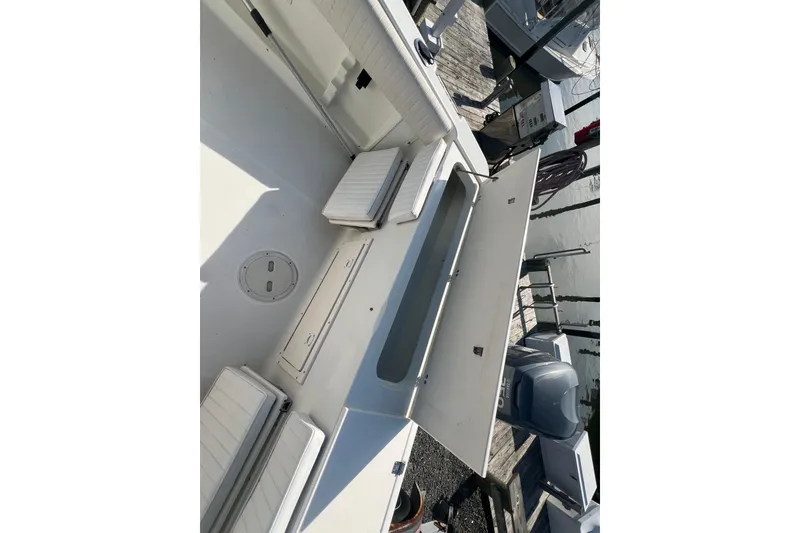 Slide: The Image of 2000 Hydra-Sports 230 Seahorse CC boat interior with open storage compartments. - 21