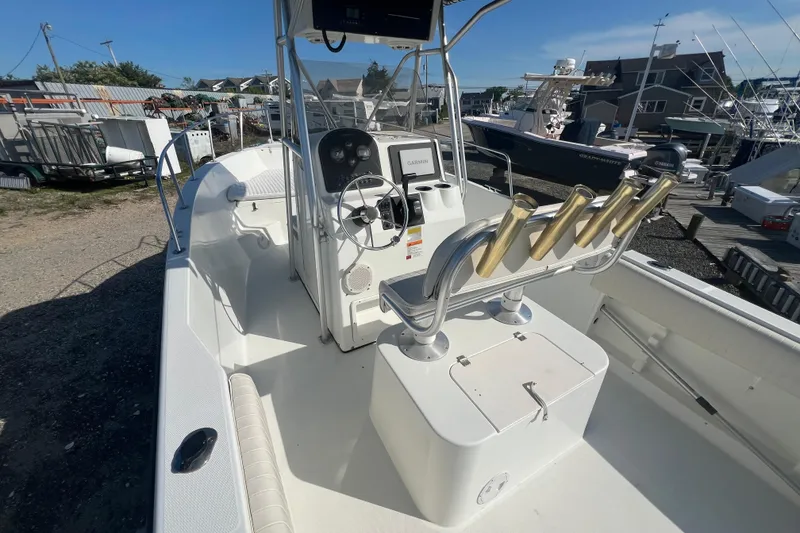 Slide: The Image of 2000 Hydra-Sports 230 Seahorse CC boat interior with steering console and rod holders. - 7