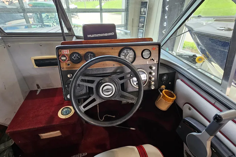 Slide: The Image of Interior of a 1988 Crestliner 2281 boat showing steering wheel and dashboard controls. - 14