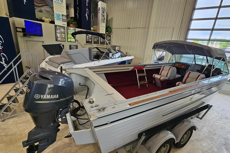 Slide: The Image of 1988 Crestliner 2281 boat with Yamaha outboard motor, displayed indoors on a trailer. - 3
