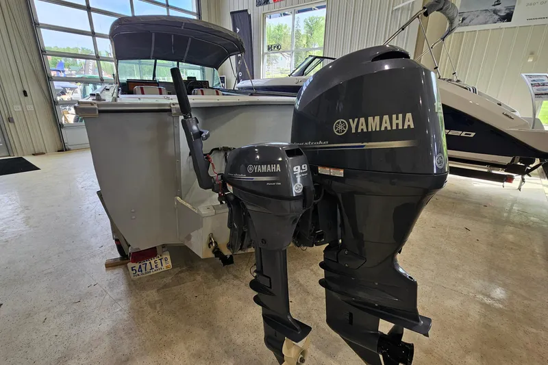 Slide: The Image of 1988 Crestliner 2281 boat with Yamaha outboard motors in a showroom. - 5