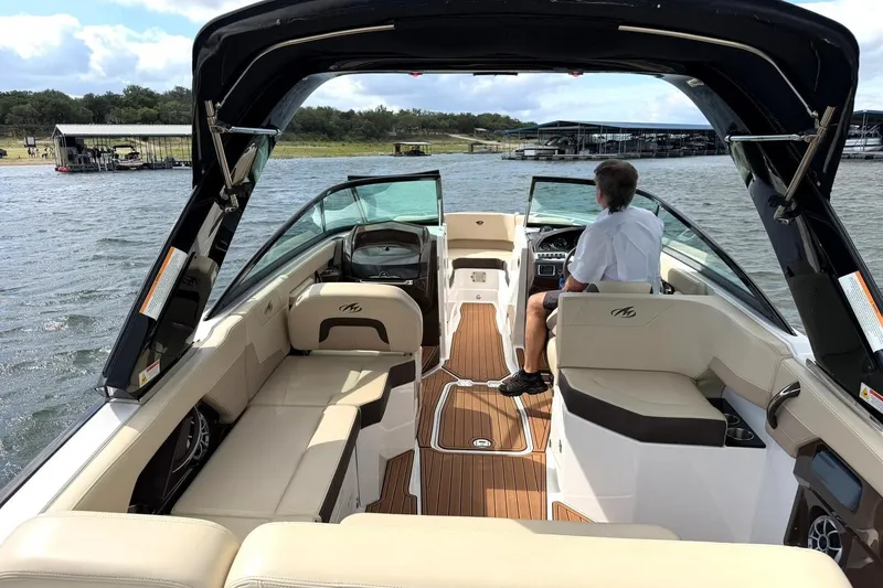 Slide: The Image of 2016 Monterey 258SS Super Sport boat interior with seating and helm on a lake. - 15