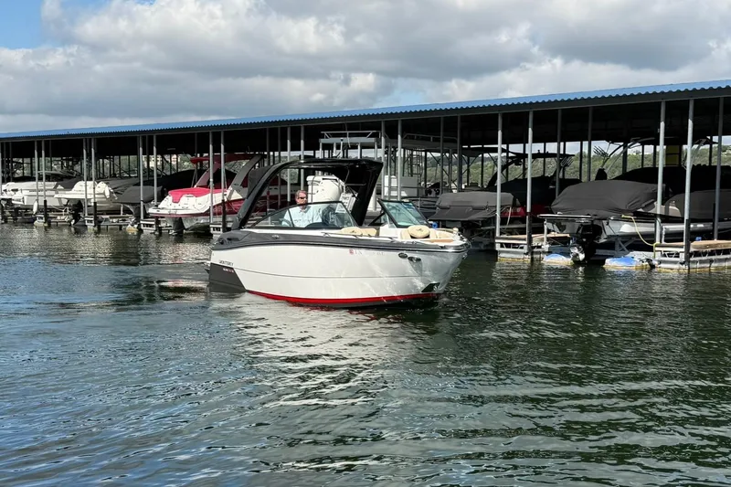 Slide: The Image of 2016 Monterey 258SS Super Sport boat docked at marina under cloudy sky. - 18