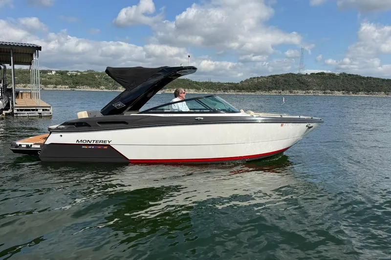 Slide: The Image of 2016 Monterey 258SS Super Sport boat on a lake under a partly cloudy sky. - 20