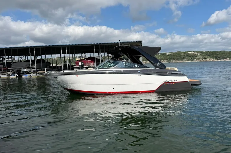 Slide: The Image of 2016 Monterey 258SS Super Sport boat on a lake under a cloudy sky. - 23