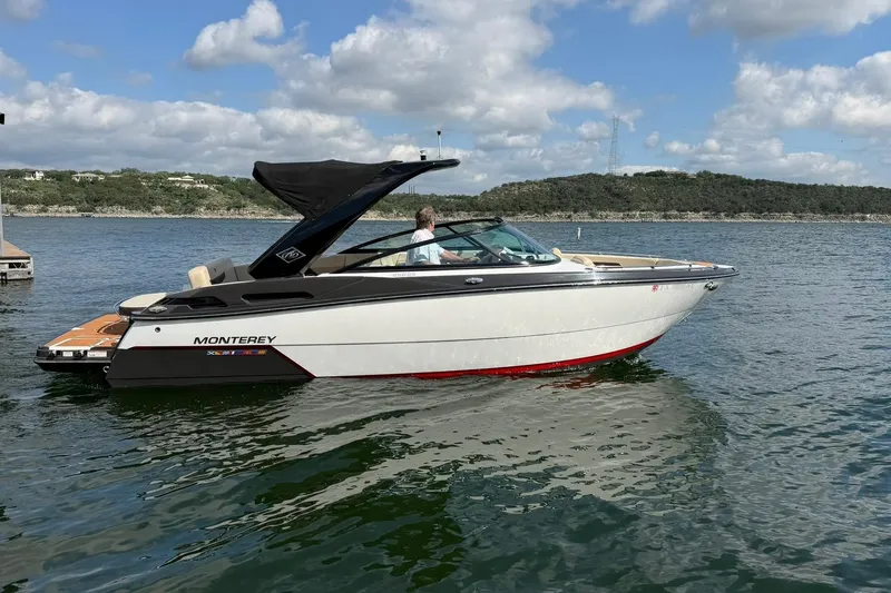 Slide: The Image of 2016 Monterey 258SS Super Sport boat on a scenic lake under a partly cloudy sky. - 25
