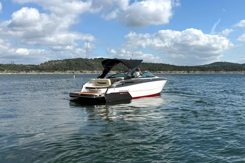 Slide: The Image of 2016 Monterey 258SS Super Sport boat on a scenic lake under a blue sky. - 26