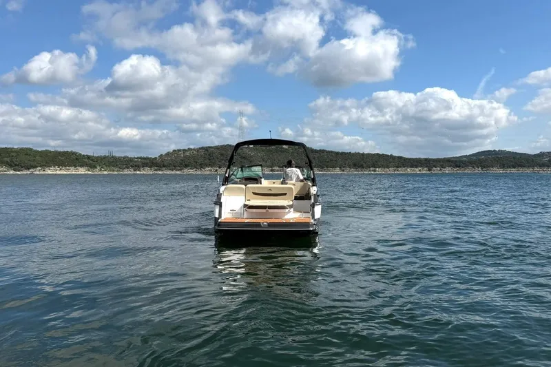 Slide: The Image of 2016 Monterey 258SS Super Sport boat on a serene lake under a partly cloudy sky. - 27