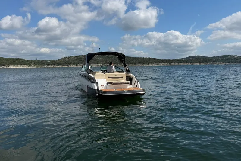 Slide: The Image of 2016 Monterey 258SS Super Sport boat on a serene lake under a cloudy sky. - 28