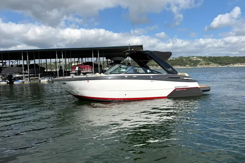 Slide: The Image of 2016 Monterey 258SS Super Sport boat on calm water under a partly cloudy sky. - 29