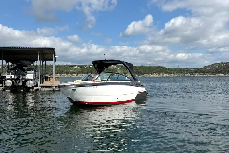Slide: The Image of 2016 Monterey 258SS Super Sport boat on a lake under a partly cloudy sky. - 32