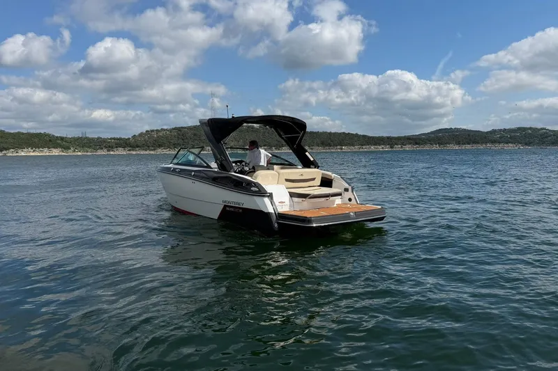 Slide: The Image of 2016 Monterey 258SS Super Sport boat on a scenic lake under a cloudy sky. - 33