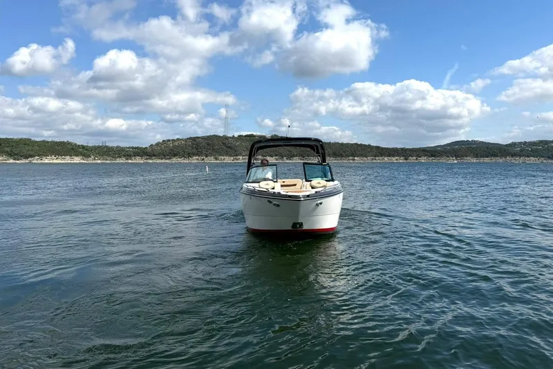 Slide: The Image of 2016 Monterey 258SS Super Sport boat on a scenic lake under a partly cloudy sky. - 37