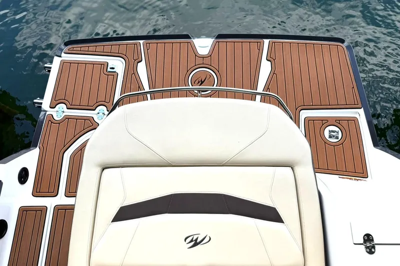 Slide: The Image of 2016 Monterey 258SS Super Sport boat with teak-style deck and cushioned seating by the water. - 6