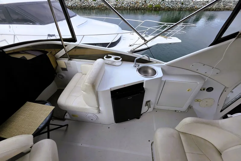Slide: The Image of 2001 Carver 396 Aft Cabin Motor Yacht interior with seating, sink, and mini fridge. - 16