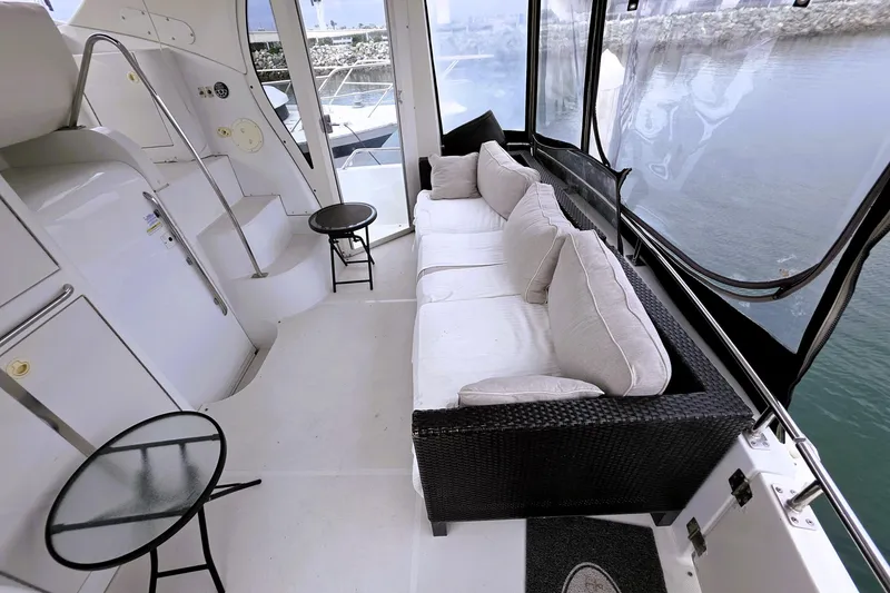 Slide: The Image of 2001 Carver 396 Aft Cabin Motor Yacht interior with cozy seating and scenic water view. - 17