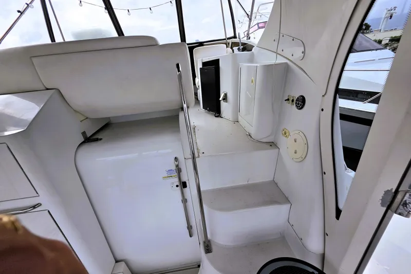 Slide: The Image of Interior view of 2001 Carver 396 Aft Cabin Motor Yacht, featuring white seating and steps. - 19