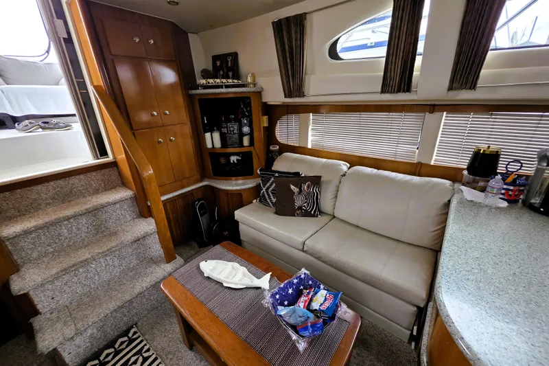 Slide: The Image of Interior of 2001 Carver 396 Aft Cabin Motor Yacht with cozy seating and wooden cabinetry. - 2
