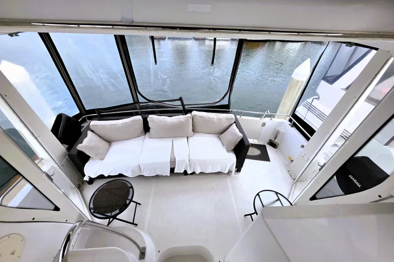 Slide: The Image of 2001 Carver 396 Aft Cabin Motor Yacht interior with cozy seating and water view. - 21