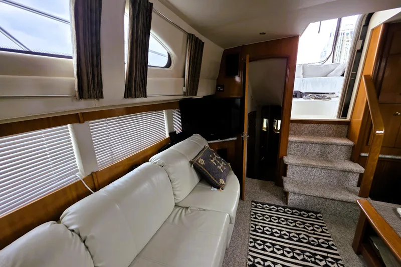 Slide: The Image of Interior of 2001 Carver 396 Aft Cabin Motor Yacht with cozy seating and elegant decor. - 4