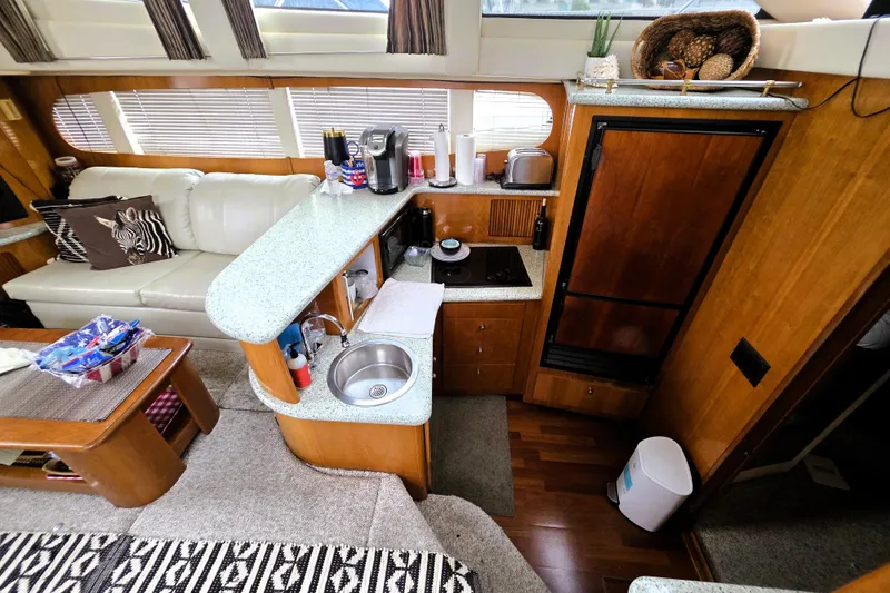 Slide: The Image of Interior of 2001 Carver 396 Aft Cabin Motor Yacht with kitchenette and seating area. - 5