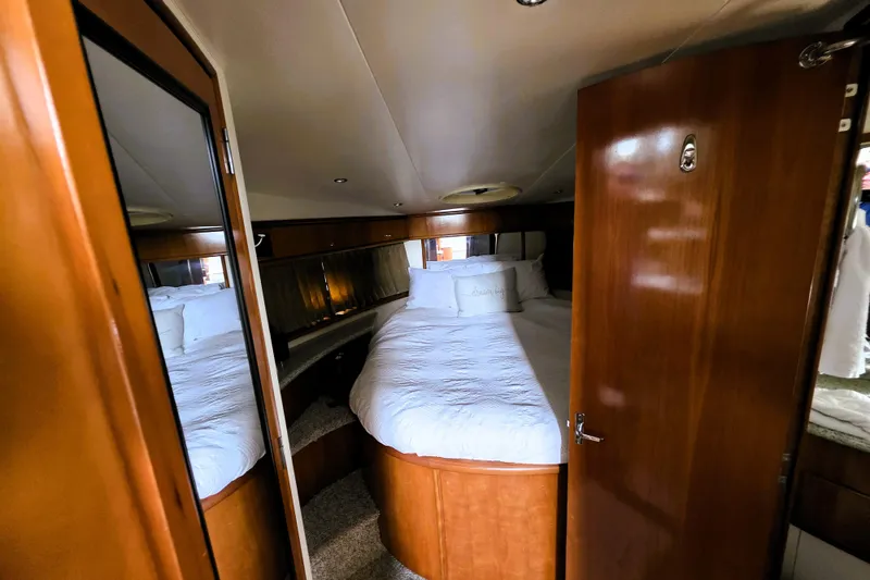 Slide: The Image of Interior of 2001 Carver 396 Aft Cabin Motor Yacht with cozy bedroom and wooden finishes. - 7