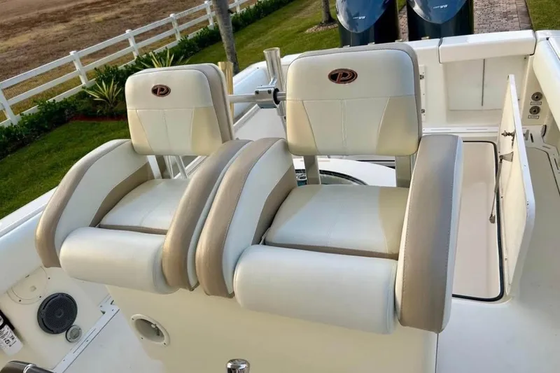Slide: The Image of 2008 Pursuit C 340 Center Console boat with dual cushioned seats and sleek design. - 10