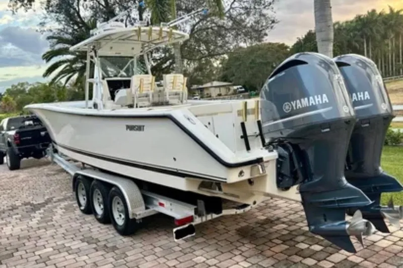 Slide: The Image of 2008 Pursuit C 340 Center Console boat with twin Yamaha engines on a trailer. - 3