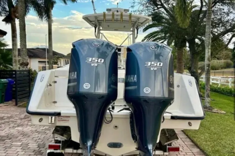 Slide: The Image of 2008 Pursuit C 340 Center Console with twin Yamaha 350 V8 engines, parked outdoors. - 4