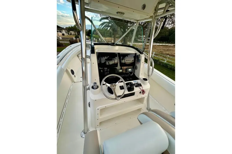 Slide: The Image of 2008 Pursuit C 340 Center Console boat interior with steering wheel and controls. - 7