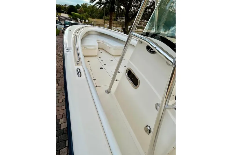 Slide: The Image of 2008 Pursuit C 340 Center Console boat with sleek white deck and stainless steel railings. - 9