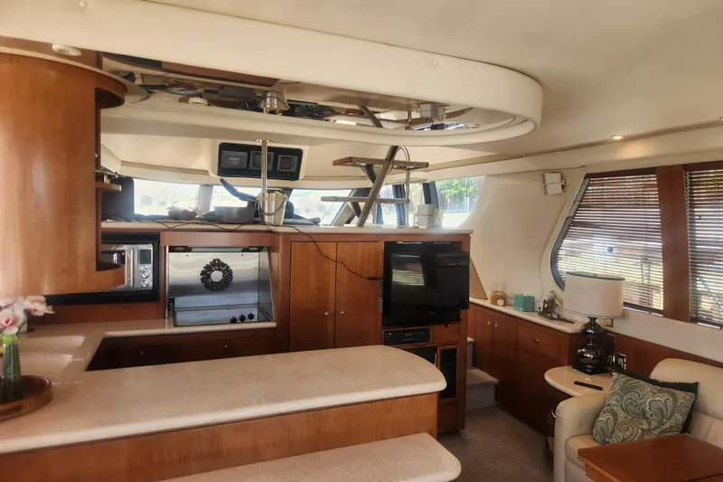 Slide: The Image of Interior of 1998 Carver 530 Voyager Pilothouse with modern kitchen and cozy seating area. - 10