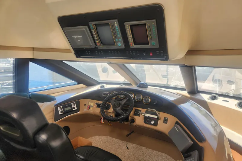 Slide: The Image of Interior view of 1998 Carver 530 Voyager Pilothouse helm with navigation equipment. - 13