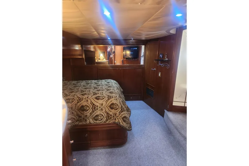 Slide: The Image of Luxurious interior of 1998 Carver 530 Voyager Pilothouse with elegant wood finishes and cozy bedding. - 14