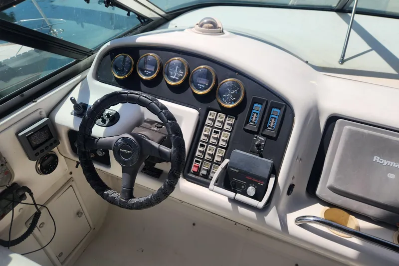 Slide: The Image of 1998 Carver 530 Voyager Pilothouse helm with steering wheel, gauges, and navigation equipment. - 15