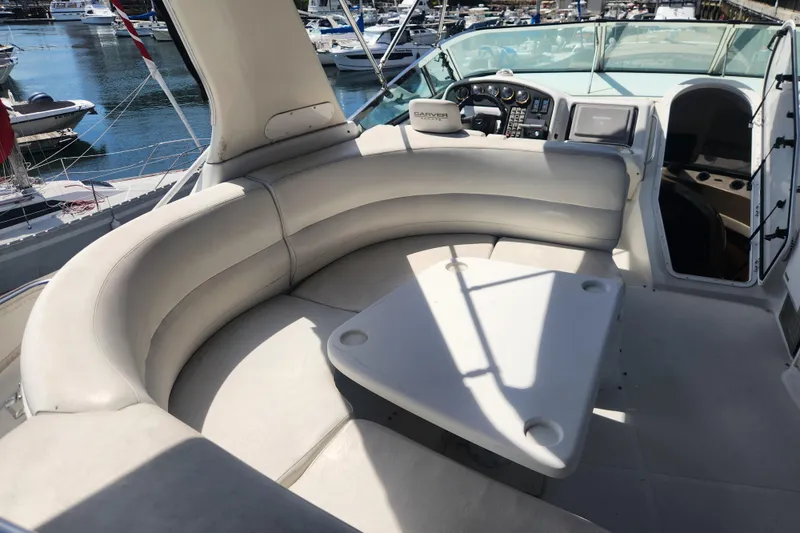 Slide: The Image of Luxurious seating area on a 1998 Carver 530 Voyager Pilothouse yacht, docked at a marina. - 17