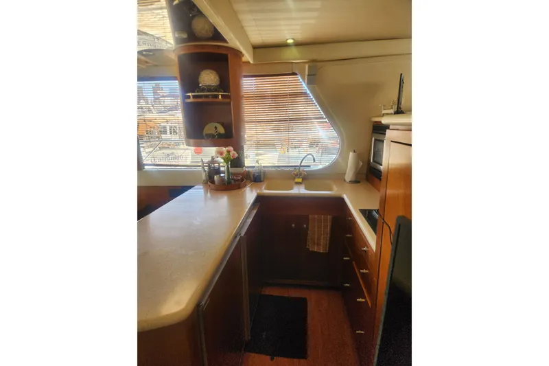 Slide: The Image of Luxurious kitchen interior of 1998 Carver 530 Voyager Pilothouse yacht with wooden cabinetry. - 20