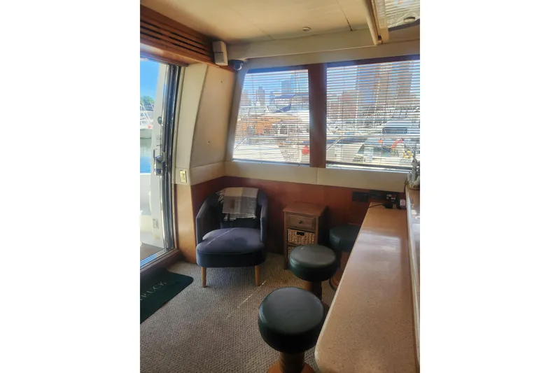 Slide: The Image of Interior of 1998 Carver 530 Voyager Pilothouse with seating and large windows. - 22