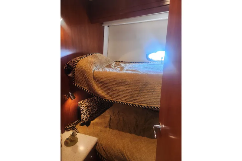 Slide: The Image of Interior of 1998 Carver 530 Voyager Pilothouse with cozy bunk beds and wooden paneling. - 24