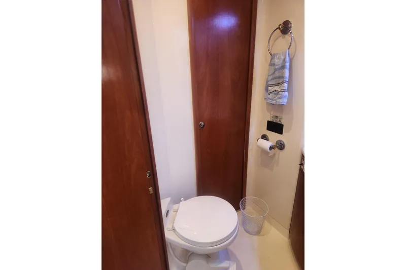 Slide: The Image of Bathroom interior of 1998 Carver 530 Voyager Pilothouse yacht, featuring wooden doors and fixtures. - 25