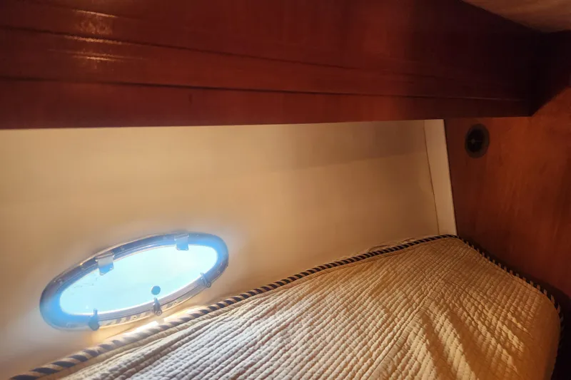 Slide: The Image of Interior cabin of 1998 Carver 530 Voyager Pilothouse with porthole and bedding. - 27
