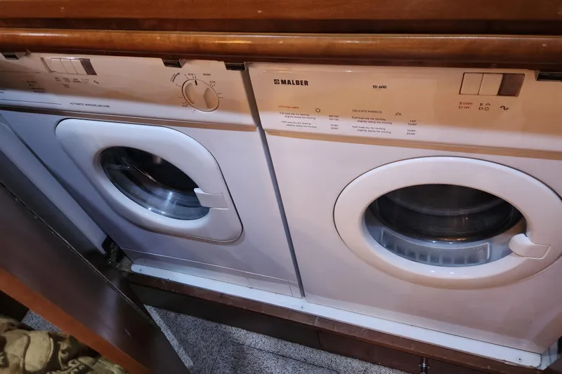 Slide: The Image of Laundry appliances inside 1998 Carver 530 Voyager Pilothouse yacht, featuring Malber washer and dryer. - 28